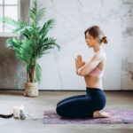 Woman Meditating With Candles and Incense